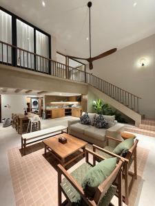 a living room with a couch and a table at Pano Samui Beachfront Villas in Nathon Bay