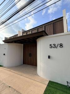 a building with two garages with numbers on it at Pano Samui Beachfront Villas in Nathon Bay +99 photos