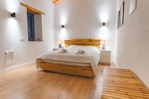 a bedroom with a bed with two towels on it at The Courtyard Episkopi Guest Houses in Episkopi Limassol