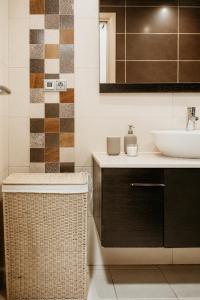 a bathroom with a sink and a mirror at Alta de Faro in Faro +10 photos