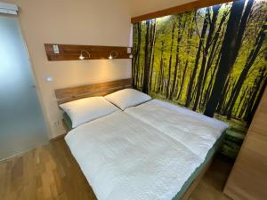 a bedroom with a bed with a window with trees at Ferienwohnung historisches Teisendorf in Teisendorf