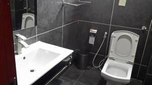 a bathroom with a white toilet and a sink at FT Hotel in Addis Ababa