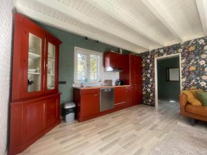 a kitchen with red cabinets and a counter top at appartement Elperhof 16B in Schoonloo +12 photos