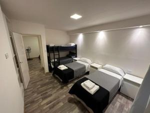 a hotel room with two beds and a mirror at Terrazas del Gracian in La Puerta +8 photos