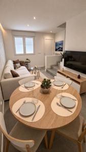a living room with a table and a couch at Casa Cuca O Grove in O Grove