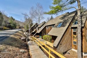a house with a wooden walkway next to a road at Windham Mountain Condo with Deck & Stunning Views in Windham