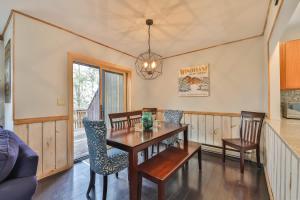 a dining room with a wooden table and chairs at Windham Mountain Condo with Deck & Stunning Views in Windham +13 photos