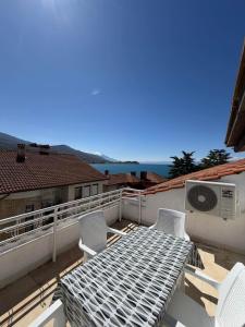 a balcony with a table and chairs on a roof at Villa Fantasy Premium Lakeview in Ohrid