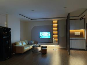 a living room with a couch and a tv at KP Home in Xuân Trach +7 photos