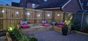 a wooden bench with pillows on a fence at Kings Sconce in South Muskham