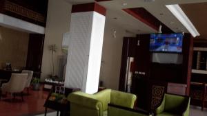 a living room with a couch and a television in a room at FT Hotel in Addis Ababa +30 photos