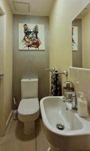 a bathroom with a white toilet and a sink at Kings Sconce in South Muskham