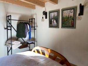 a bedroom with a bed and some pictures on the wall at Mas Casalprim in Sant Feliu de Pallerols +3 photos