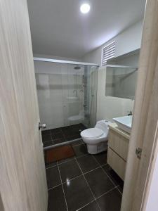 a bathroom with a shower and a toilet and a sink at Lindo apto cerca a todo! in Sabaneta +3 photos