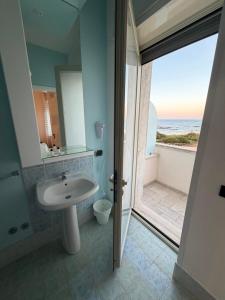 a bathroom with a sink and a view of the ocean at Hotel La Plancia in Otranto +76 photos