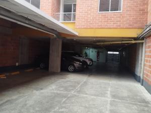a parking garage with a car parked in it at Lindo apto cerca a todo! in Sabaneta