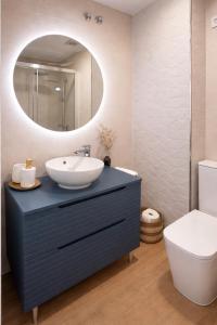 a bathroom with a sink and a mirror at Casa Cuca O Grove in O Grove +7 photos