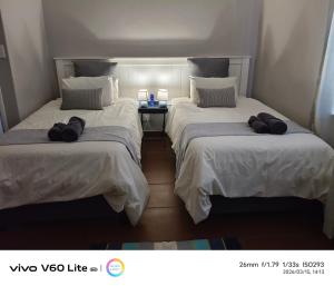 two beds in a room with towels on them at Firehouse self-catering unit 6 in Wellington