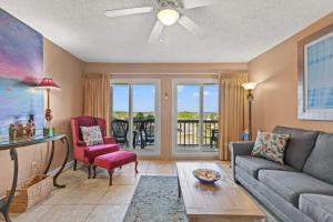 a living room with a couch and a table at A-110, Pinnacle Port in Panama City Beach