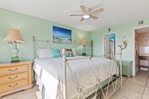a bedroom with a bed and a ceiling fan at A-110, Pinnacle Port in Panama City Beach +13 photos