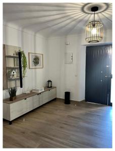 a living room with a black door and a table at Casa Veracruz in Alora