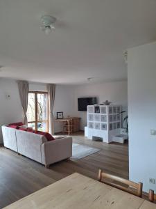 a living room with a white couch and a television at Ferienwohnung Theresia in Laufen