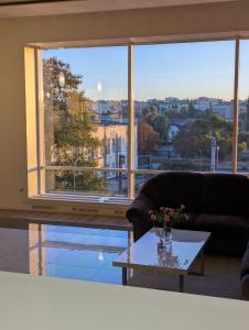 a living room with a table and a large window at MARISS hotel & business in Kropyvnytskyi