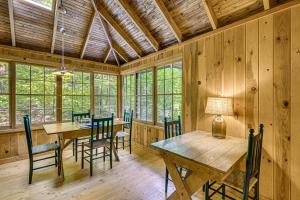 a dining room with a wooden table and chairs at Rustic Cabin w/ Squam Lake Access & Fireplace! in Holderness