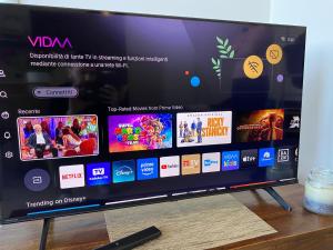 a television sitting on top of a wooden table at Appartamento Gardenia in Saronno +10 photos
