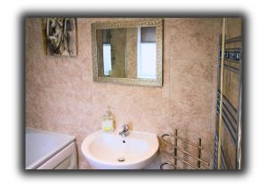 a bathroom with a sink and a mirror at Pitchside Quarters Near Anfield sleeps 7 in Liverpool +17 photos