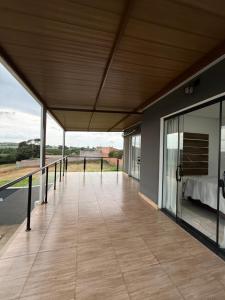a large balcony with a bed and a bed sqor at Chácara Vittorino in Artur Nogueira