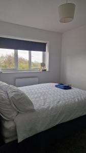 a white bedroom with a bed with a window at Amani Sanctuary 2 Bedroom House in Sherburn Hill