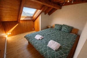 a bedroom with a bed with two pillows on it at JSM è in Därligen