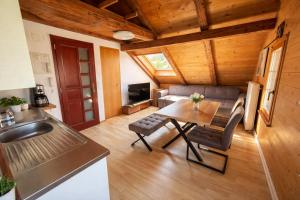 a kitchen and living room with a table and a couch at JSM è in Därligen