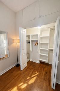 a room with a closet with white doors and wooden floors at Flexhome West Town - Spacious 2BR Duplex - Sleeps 8 in Chicago