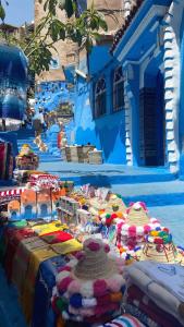a blue building with a table filled with colorful items at Morocco PALACE in Chefchaouen