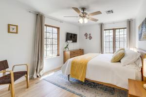 a bedroom with a bed and a ceiling fan at Midtown Tulsa Gem w/ MCM Decor: Private Deck, Yard in Tulsa