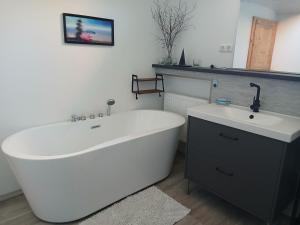 a bath tub and a sink in a bathroom at Landhotel Eisdorf in Eisdorf +12 photos