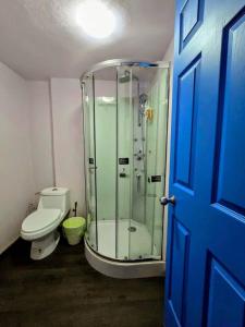 a bathroom with a glass shower and a toilet at Suite Azul 3 personas comoda y equipada in Mexico City +73 photos