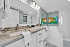a bathroom with two sinks and a large mirror at Tranquillity 140 - A Wave From It All in Inlet Beach