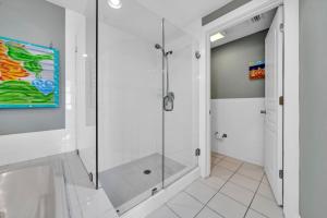 a shower in a bathroom with a glass shower stall at Tranquillity 140 - A Wave From It All in Inlet Beach
