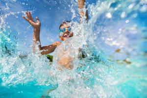 a man in the water with his hand in the water at Tranquillity 140 - A Wave From It All in Inlet Beach +28 photos