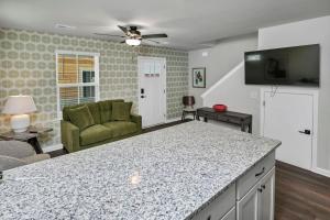 a kitchen with a counter top and a living room at Hampton Cottage - DT COLA in Columbia