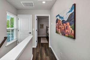 a hallway with white walls and a painting on the wall at Hampton Cottage - DT COLA in Columbia +41 photos