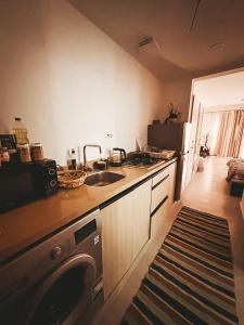 a kitchen with a sink and a dishwasher in it at Green studio in Dahab in Dahab