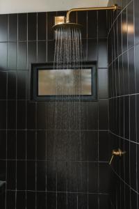 a shower with a droplet of water in a bathroom at The Orpen Kruger, Cork Tree Collection in Welverdiend +41 photos