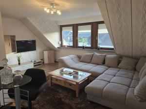 a living room with a couch and a coffee table at Ferienwohnung Moselherz in Monzelfeld