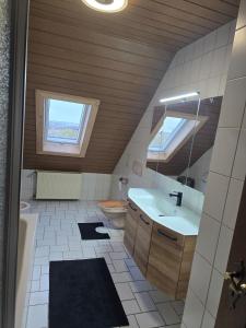 a bathroom with a sink and a mirror at Ferienwohnung Moselherz in Monzelfeld