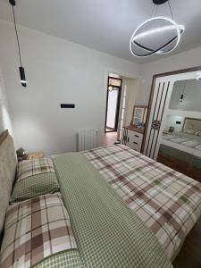 a bedroom with a bed with a plaid blanket at Sunny Escape in Gonio in Gonio
