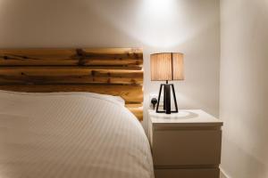 a bedroom with a bed and a table with a lamp at The Courtyard Episkopi Guest Houses in Episkopi Limassol +27 photos